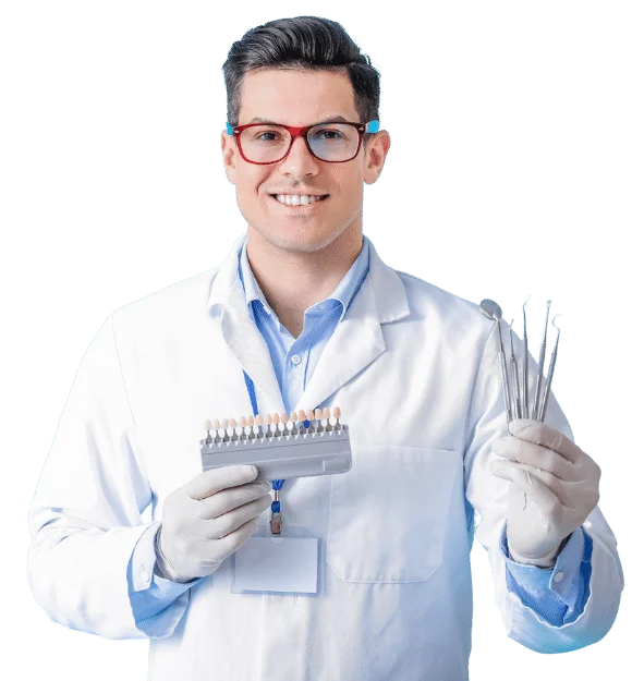 Male dentist with plastic teeth color samples and tools